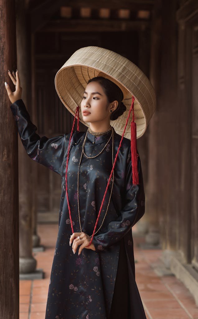 Elegant woman in traditional Vietnamese attire, Hội An setting.